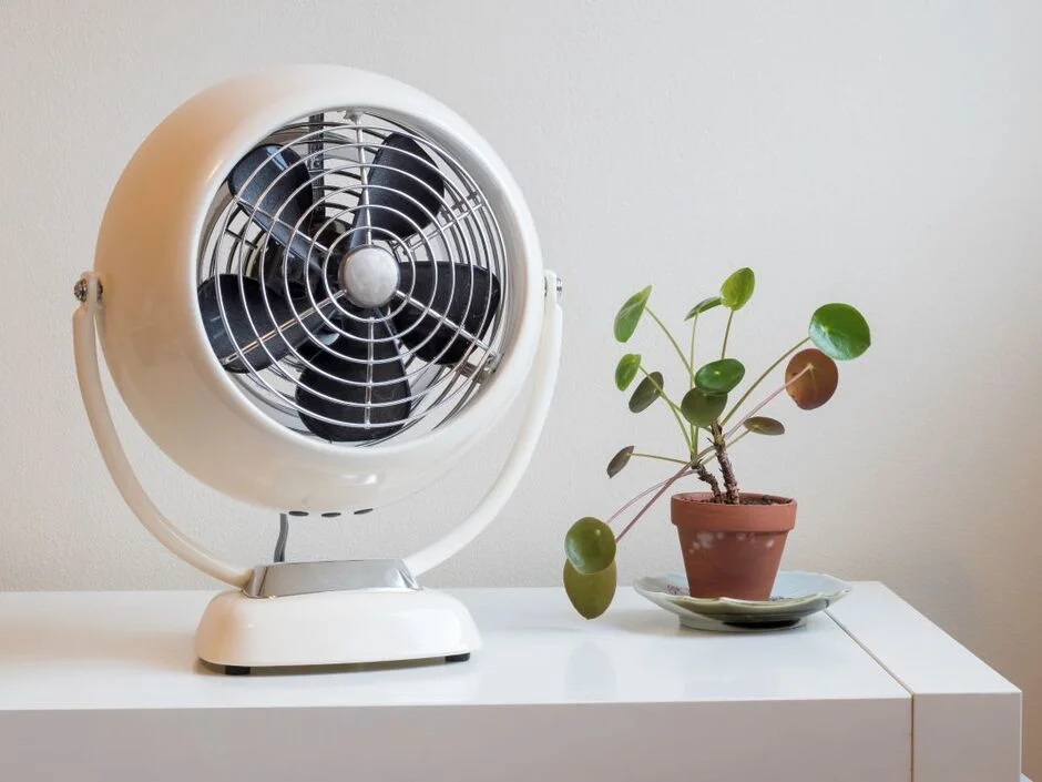 Person inspecting a Lasko fan for troubleshooting